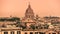 Rome skyline with old colorful houses and rooftop terraces on sunny day. Dome of San Carlo al Corso basilica on the