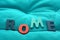 ROME, word with wooden letters on background with colored cloth