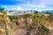 Ronda restaurants and colonial houses overlooking the scenic gorge and the Puente Nuevo bridge