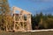 Roof beams. Sunny autumnal evening at the construction site of a wooden house. Unfinished house.