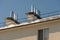 The roof of the building is covered with snow after a big snowfall against the blue sky. Ventilation pipes glisten in the sun,