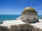 Roof of Cadiz cathedral with atlantic ocean on the background