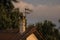 Roof, chimney and an antenna during golden hour