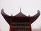 The roof of a chinese temple with a misty background