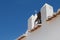 Roof of a church with a bell and cross, Portugal