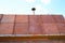 The roof of the country house covered with sheets of rusty metal