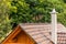 The roof of a family house with a chimney and a lightning conductor. Lightning protection. Detail of the roof