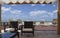 Roof in front of the sea with tanned beds, armchais, blue sky and white clouds