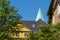 Roof and gable of a building of the Folkwang University of the Arts, spire of the basilica St. Ludgerus, Essen-Werden