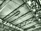 The roof of a hangar, a production hall or a sports hall. Metal structures, beams, supporting elements. Ventilation