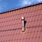 Roof of a house covered with metal tile with chimney