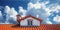 roof of house covered with new red ceramic clay tiles against blue sky background