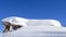 The roof of an house or hotel covered by massive quantity of fresh snow after heavy snowfall