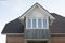 Roof of house. Roof on country house. Windows in wall