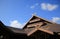 Roof of houses against blue sky.