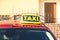 Roof light with word TAXI on car