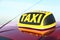 Roof light with word TAXI on car