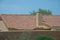 The roof of a modern house with brick chimney