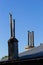 Roof of a new home. Ceramic chimney, metal roof tiles, gutters, roof window. Single family house