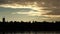 Roof and peaks of ancient castles and houses above the water at sunset sky