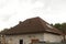 Roof Shingles - Roofing. Asphalt Roofing Shingles. Urban house or building. Bitumen tile roof. Unfinished chimney system