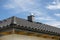 The roof of a single-family house covered with a new ceramic tile in anthracite against the blue sky, visible ridge tile, system c