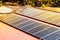 Roof with solar panels fragment under sunny blue sky