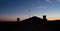 Roof with three chimneys at dawn