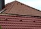 Roof tile or painted concrete, orange with ventilation and top row on the ridge. side view in contrast with another shade of burnt