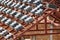 Roof under construction with stacks of roof tiles for home build