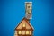 The roof of a wooden toy house with a dollar bill on the chimney. The concept of heating and energy costs