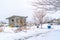 Roofed storage shed with single door on a landscape with snow at winter time