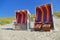 Roofed wicker beach chair at the coastline of North Sea infront of the ocean