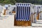 Roofed wicker beach chairs is on a beach