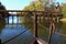 Roofed wooden pile bridge with decorative flowers, view from ship mill front part, autumn season, location Kollarovo, Slovakia, ce