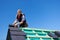 Roofer assembling edged tiles to the roof