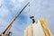 Roofer builder worker with crane installing structural Insulated Panels SIP. Building new frame energy-efficient house.