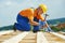 Roofer carpenter works on roof