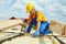 Roofer carpenter works on roof