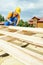 Roofer carpenter works on roof