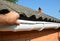 Roofer contractor installing and repair rain gutter pipeline. Guttering repair with contractor hands