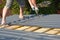 Roofer with crew gun installing metal roof sheets. Roofing construction