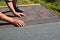 Roofer hands laying Asphalt Shingles on house construction roof. Roofing construction with Asphalt Shingles