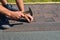 Roofer installing Asphalt Shingles on house Roofing Construction with hammer and nails. Roofing Construction. Roofing Contractor