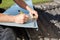 Roofer measuring and marking a metal sheet