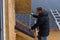 Roofer measuring tiles on a new house