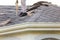 Roofer removing roof nails with roof shingle remover