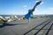 Roofer stands on his hands on the edge of the roof