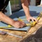 Roofer working with a protractor on a metal sheet