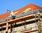 Roofer works on the roof of an old building